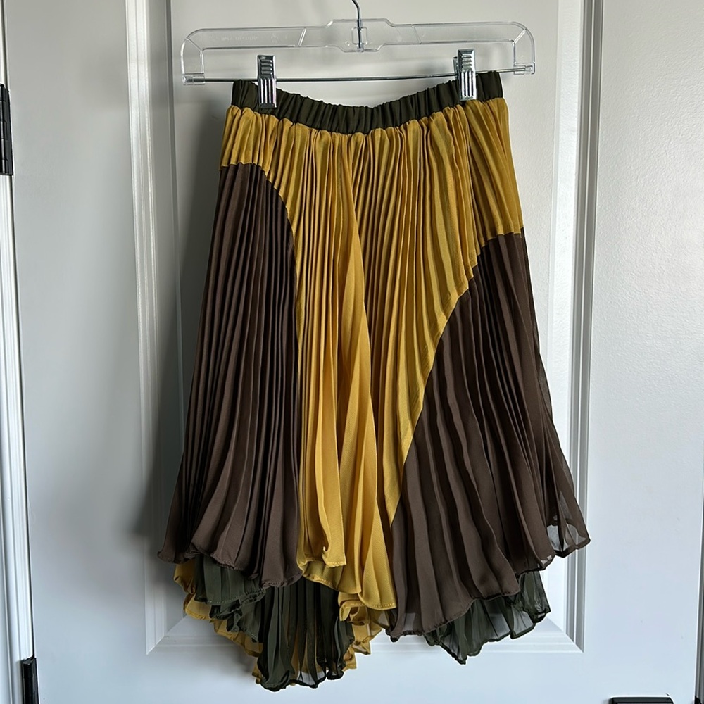 Color Pleated, asymmetrical midi skirt by Ryu. Mustard, olive and brown colors.